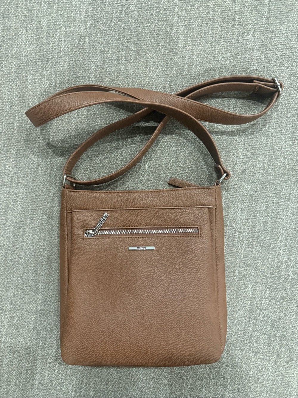Roots Flat Crossbody Bag with Front Zipper Pocket